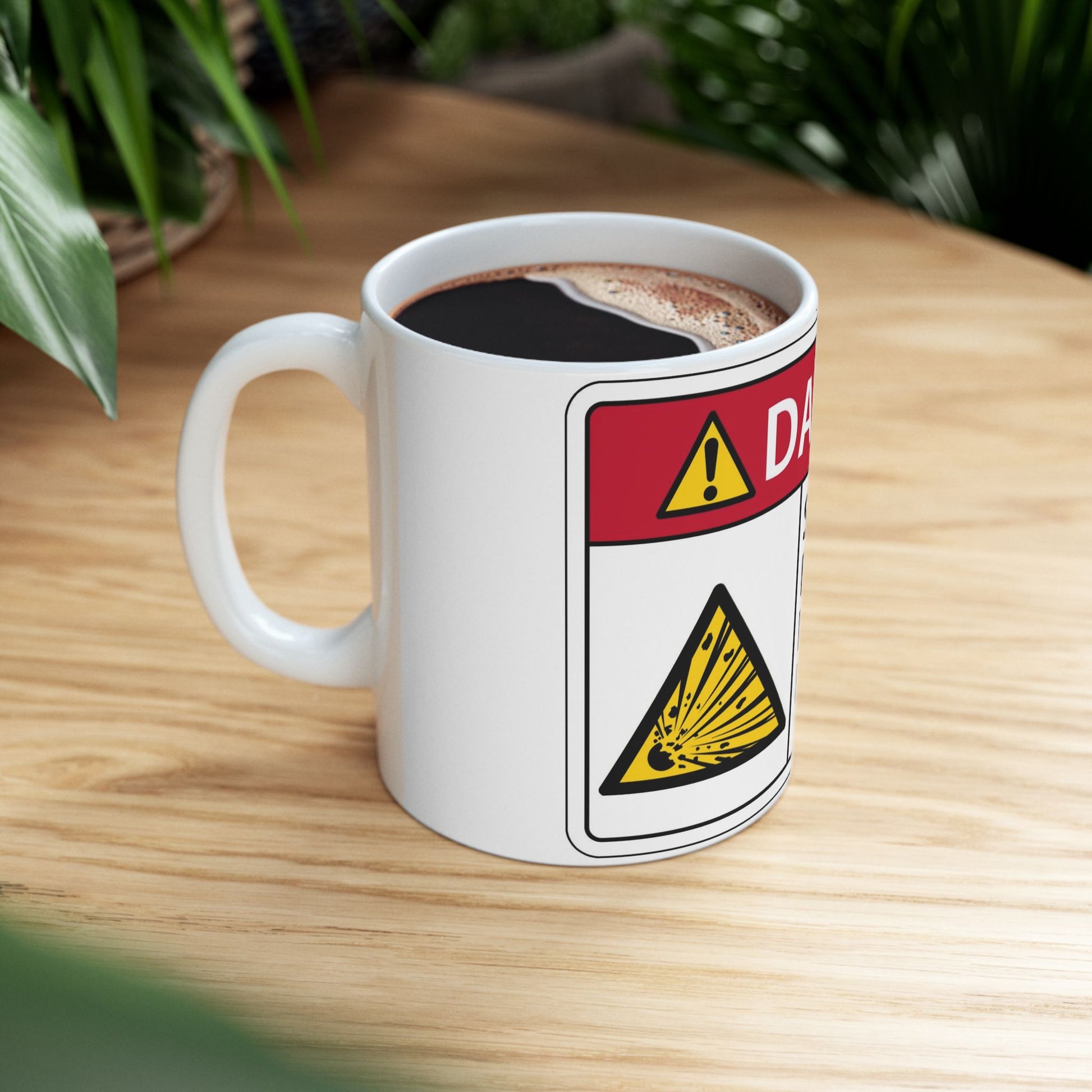 Mug with coffee and a warning label design on a wooden surface
