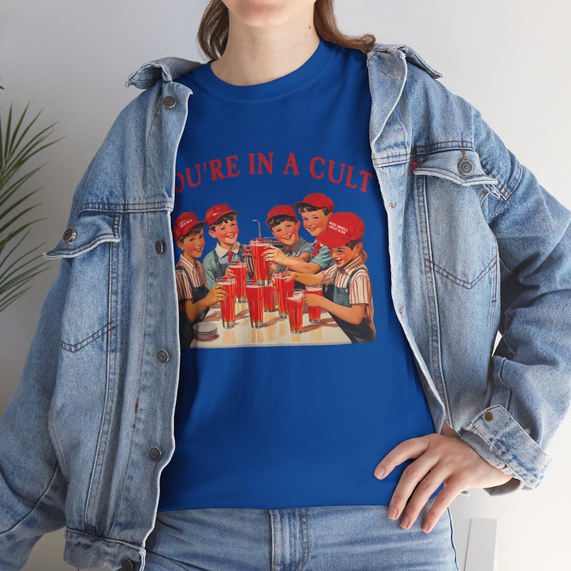 Person wearing a blue t-shirt with graphic design and denim jacket.