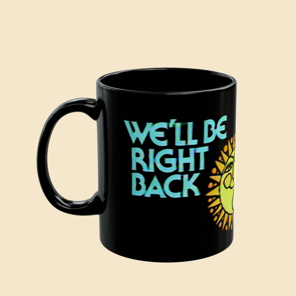 Black mug with 'We'll Be Right Back' text and sun design on a white background