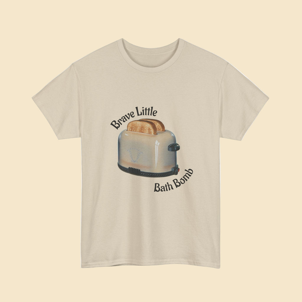 Beige t-shirt with a graphic of a toaster and text 'Brave Little Bath Bomb' on a white background
