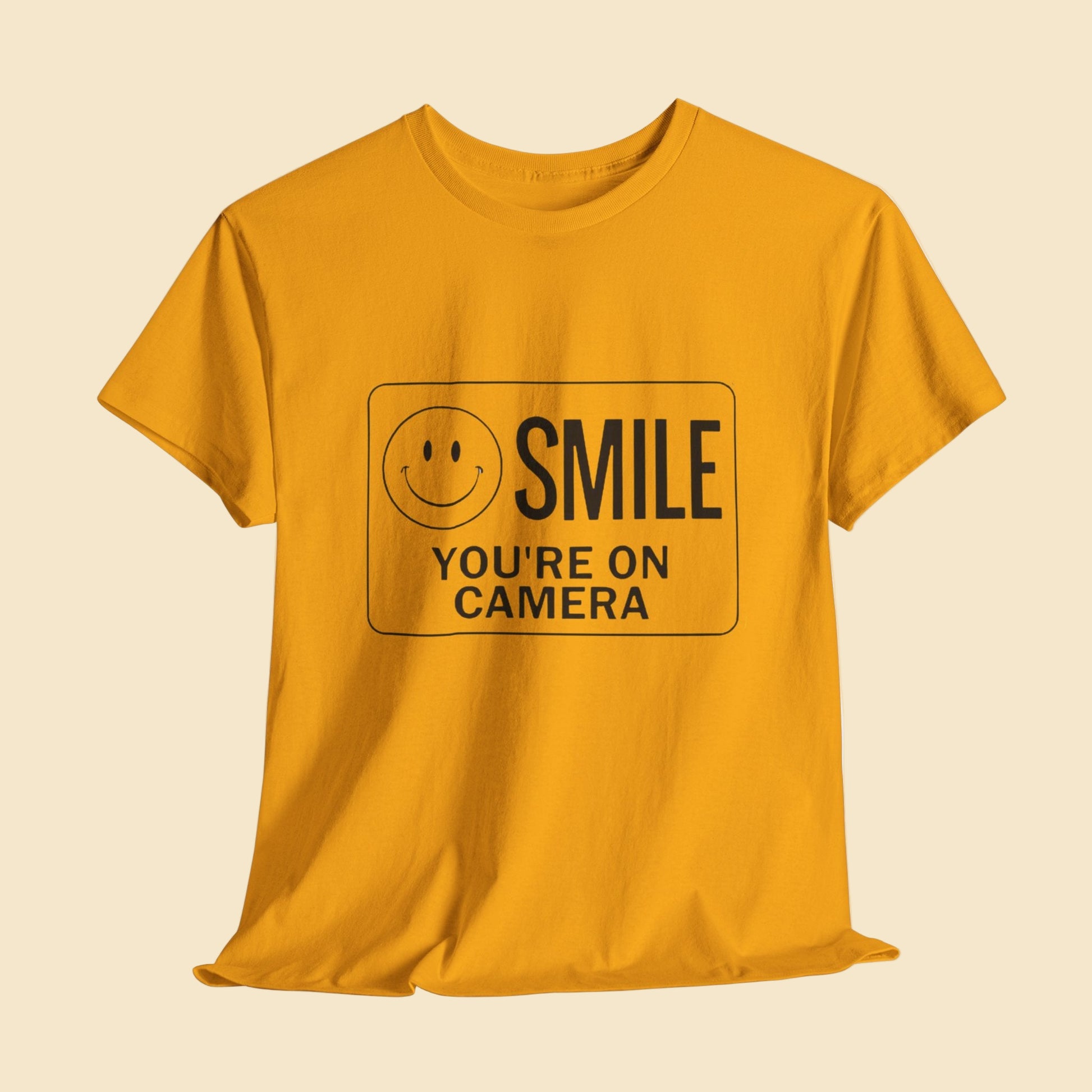 Yellow t-shirt with a smiley face and text on a white background