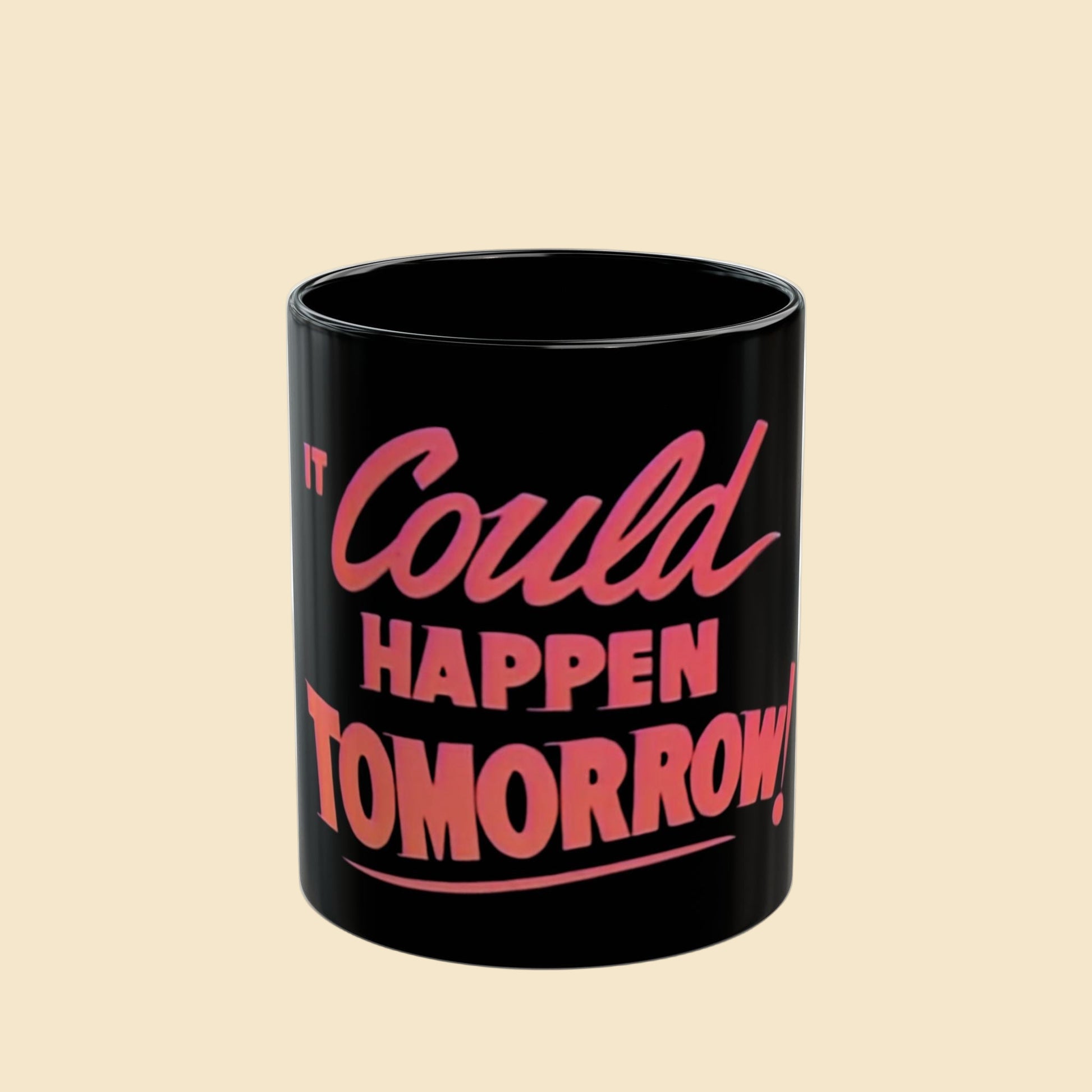 Black mug with pink text 'It Could Happen Tomorrow' on a beige background