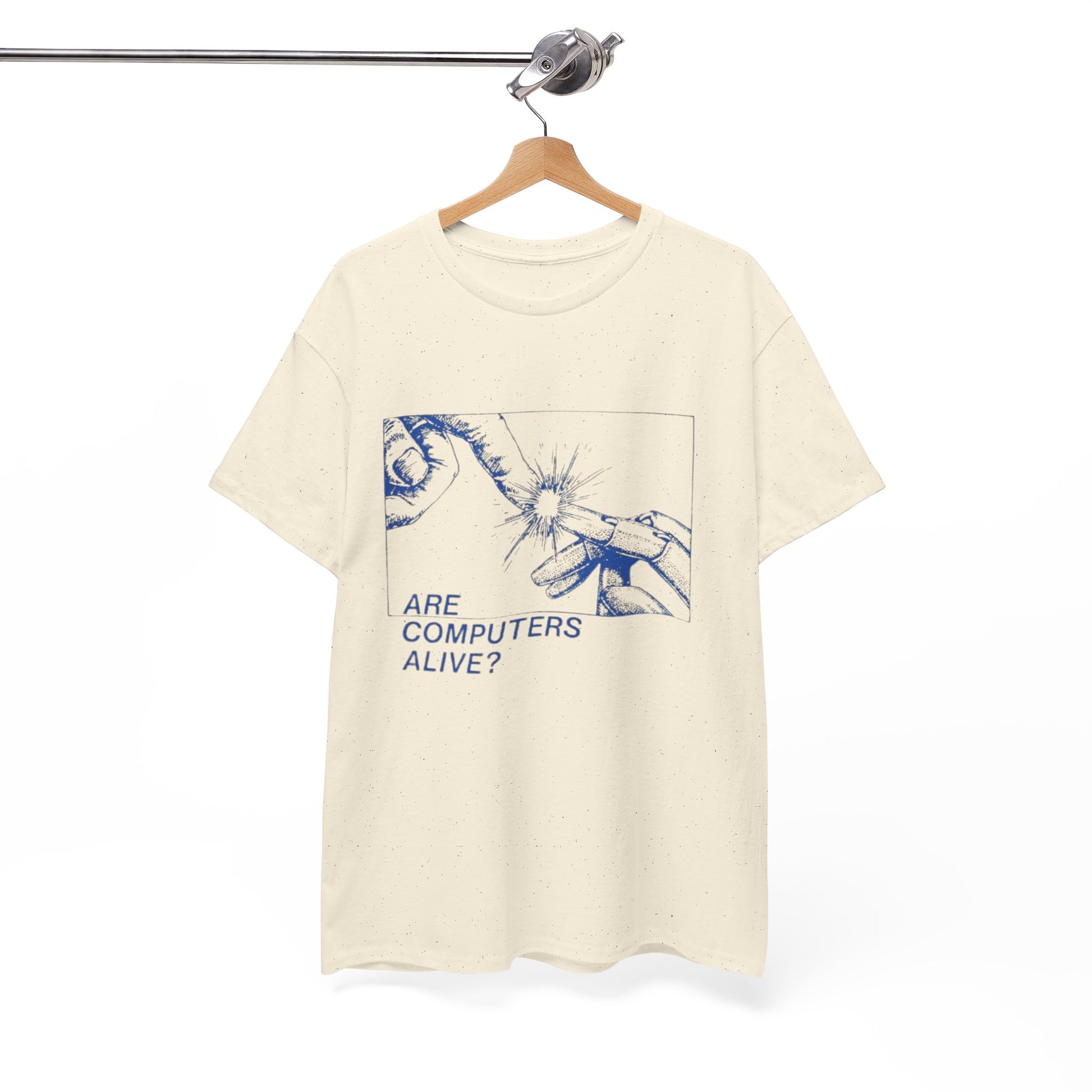 Beige t-shirt with graphic design and text 'Are Computers Alive?' on a hanger against a white background