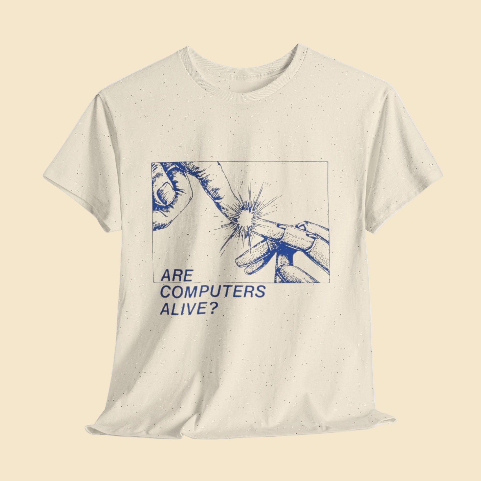 Beige t-shirt with blue graphic and text 'Are Computers Alive?' on a light gray background