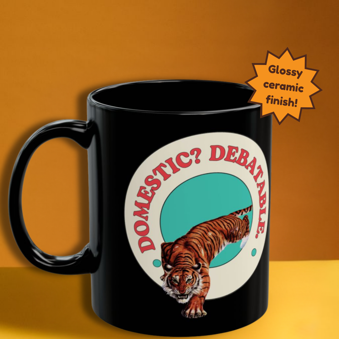 Black mug with a tiger graphic and text 'DOMESTIC? DEBATABL' on an orange background
