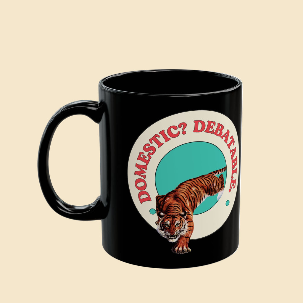 Black mug with a tiger graphic and text 'DOMESTIC? DEBATABL' on a white background