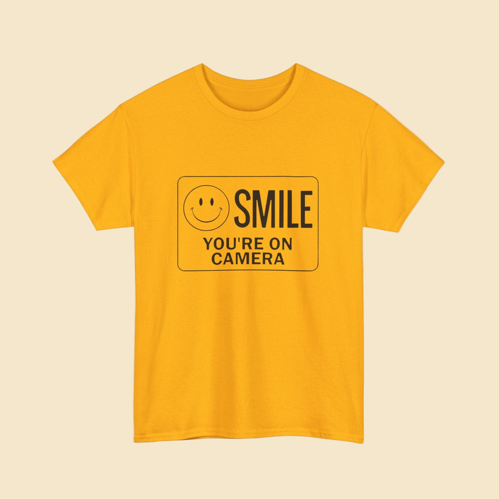 Yellow t-shirt with a smiley face and text on a beige background