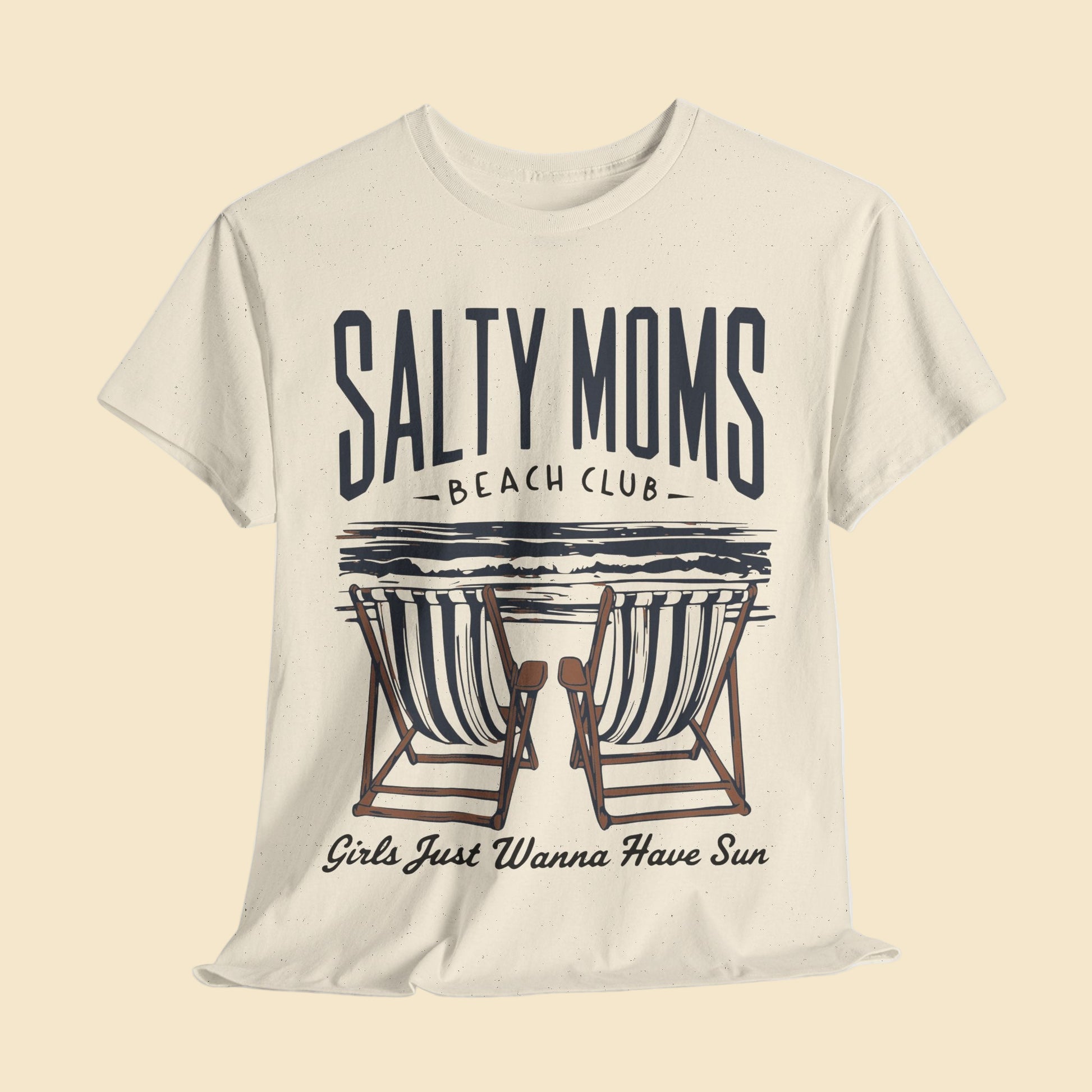 Beige t-shirt with 'Salty Moms Beach Club' graphic design on a light gray background