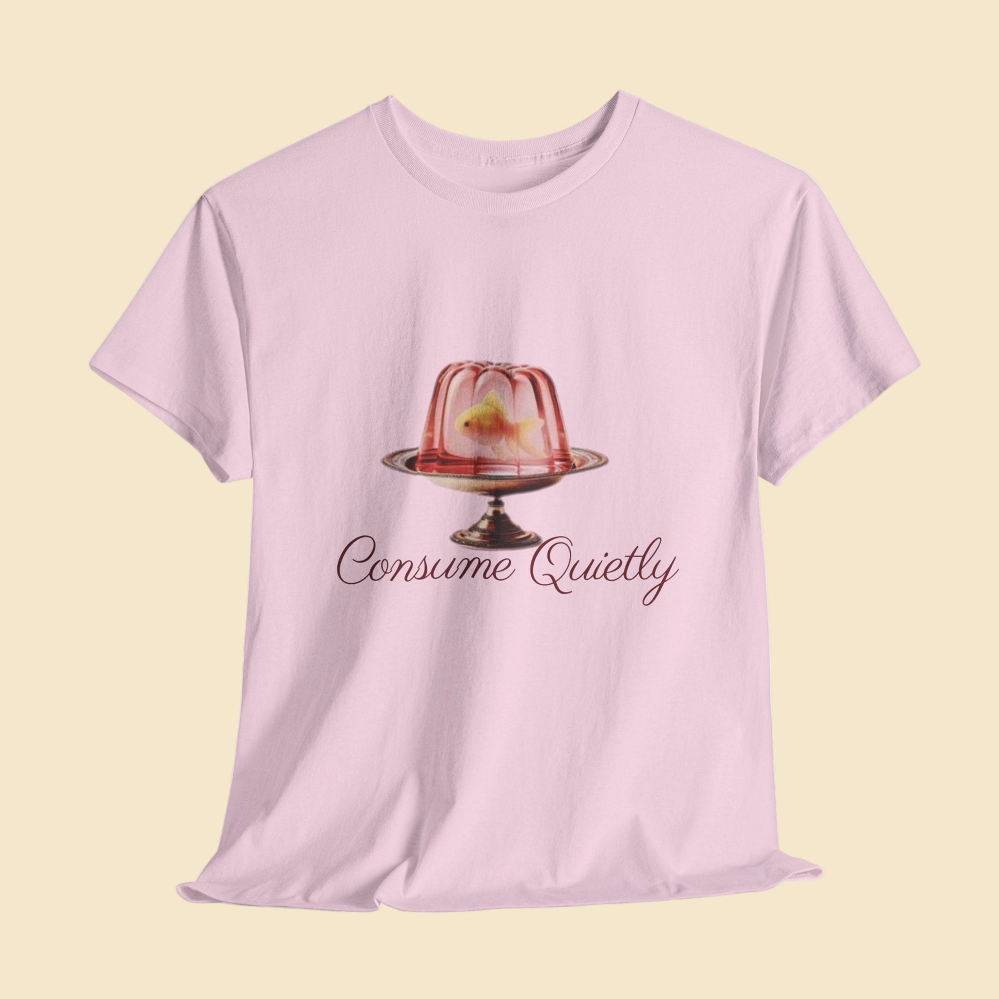 Pink t-shirt with a jelly dessert graphic and 'Consume Quietly' text on a light gray background