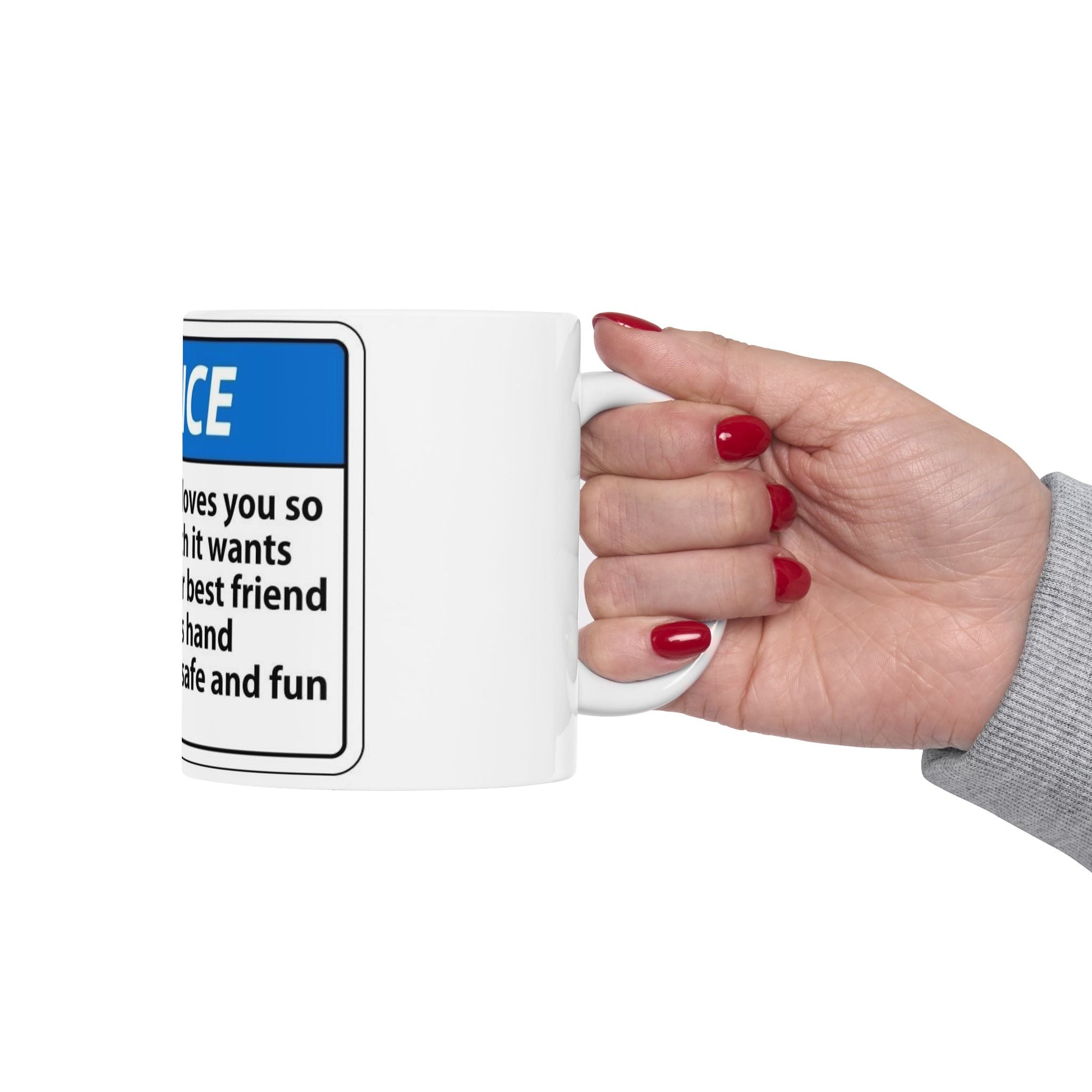 Hand holding a mug with a humorous warning label design on a white background